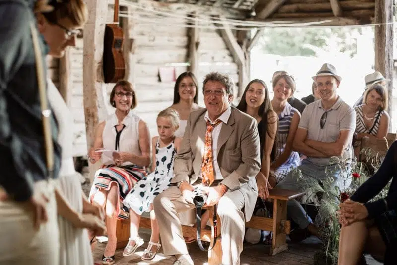 Portrait d'un invité assis sur un banc durant la cérémonie